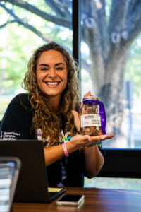 ACS worker holding up donation jar