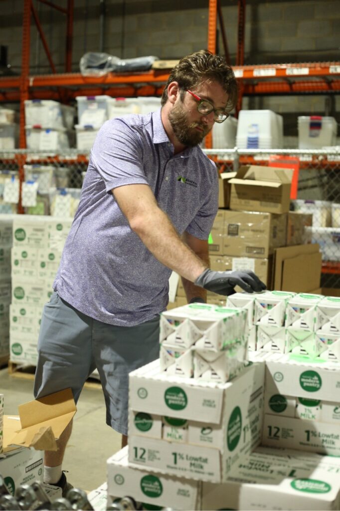 A man packing up items into a box for Feeding Southwest Virginia.