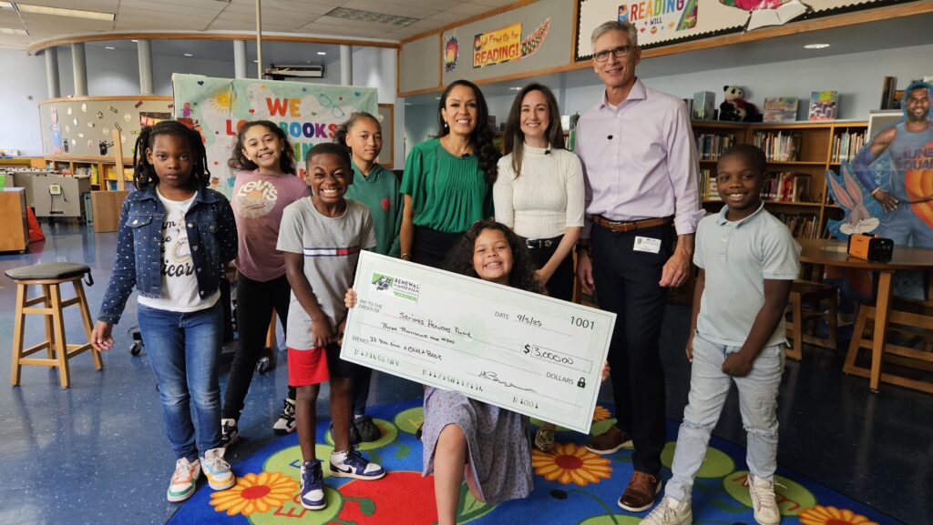 Renewal by Andersen of Central Virginia Marketing Manager Shannon Siriano and CBS 6 news anchors present a donation to If You Give a Child a Book.